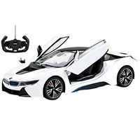 White toy car with open doors and a remote control on a white background