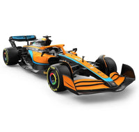 Orange and black Formula 1 car on a white background