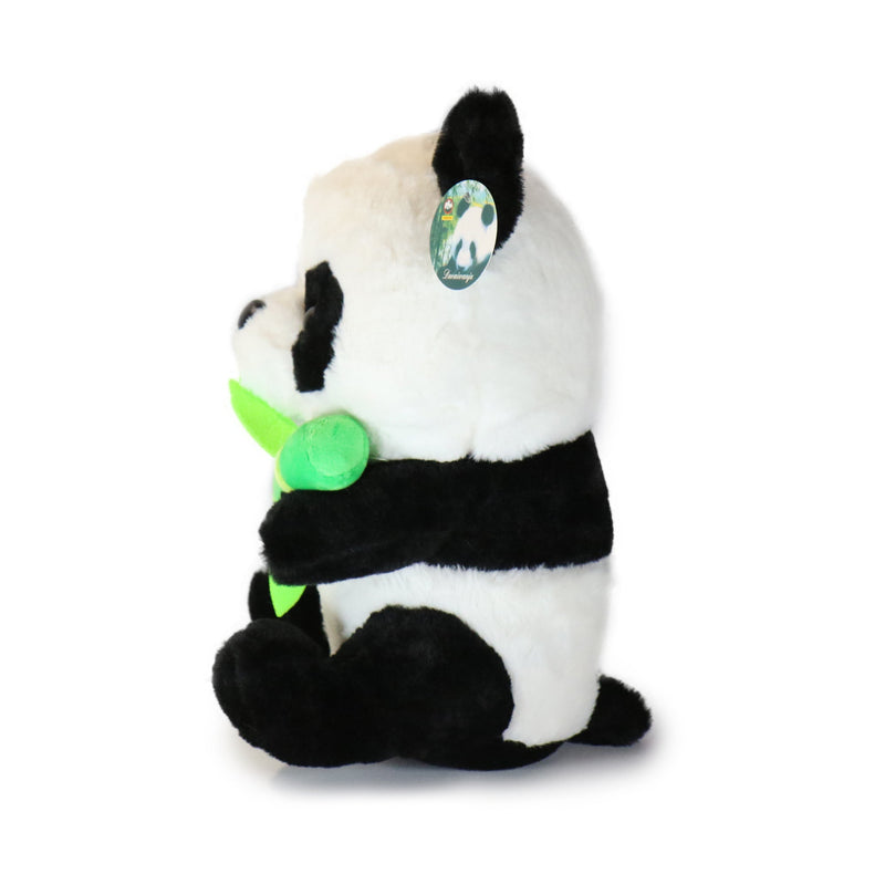 Plush panda toy holding a green leaf on a white background