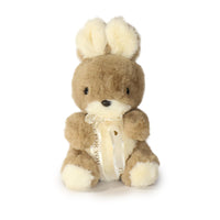 Plush toy rabbit with a bow on a white background