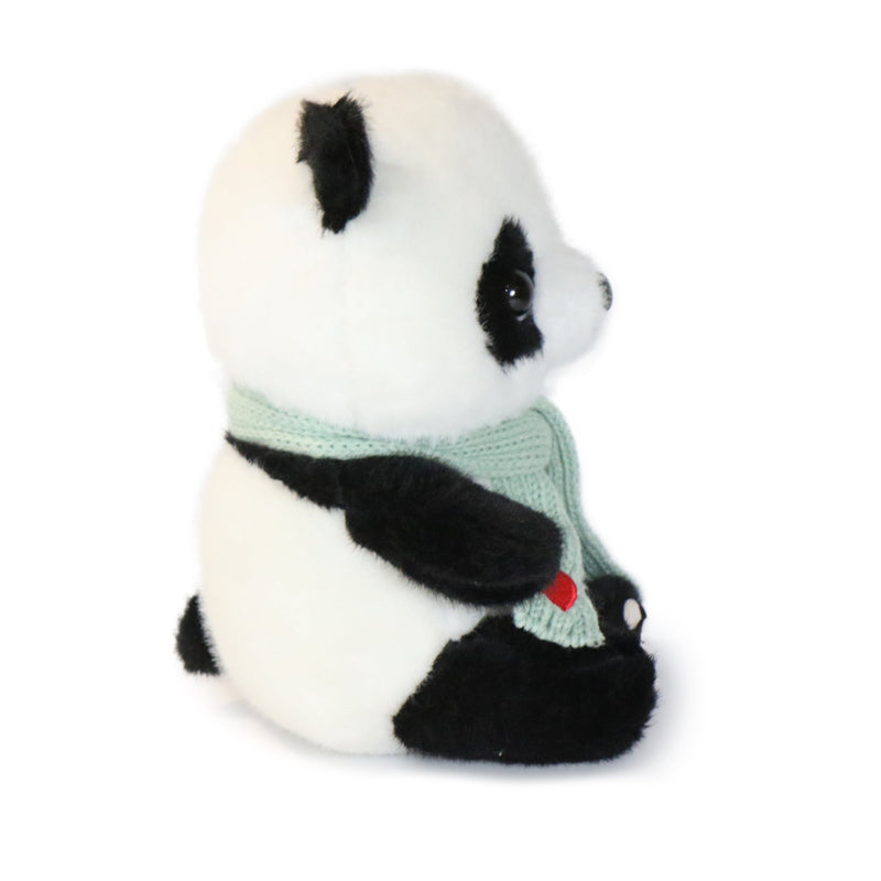 Plush panda toy wearing a sweater with a heart on a white background