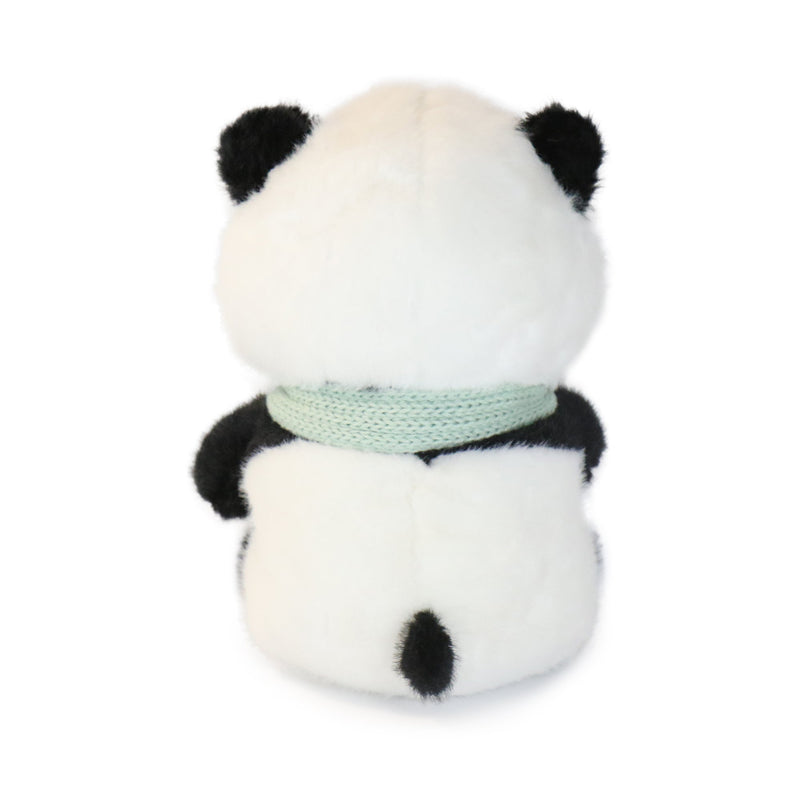 Plush panda toy with a green ribbon on a white background