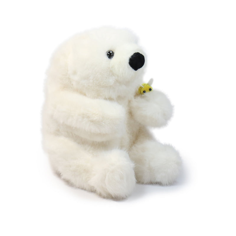 Plush polar bear holding a butterfly on a white background