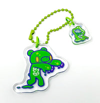 Green cartoon character charm with a beaded strap on a white background