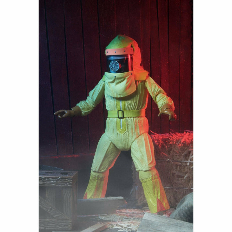 Person in a space suit with glowing green and red effects against a dark background