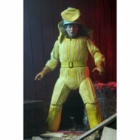 Person wearing a bright yellow space suit with a helmet in a dark setting.