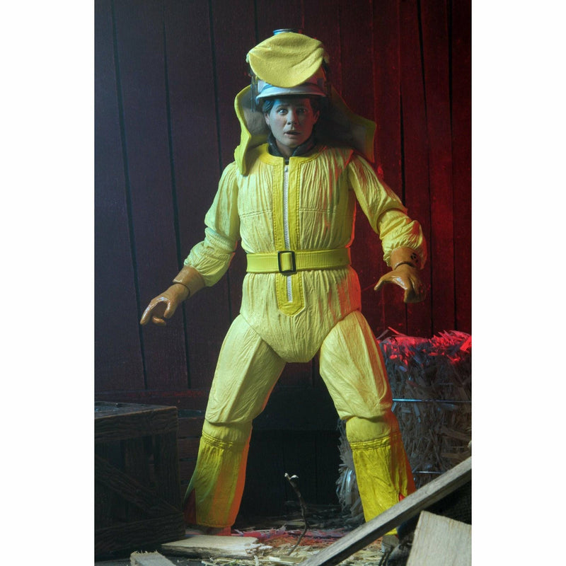 Person wearing a bright yellow space suit with a helmet in a dark setting.
