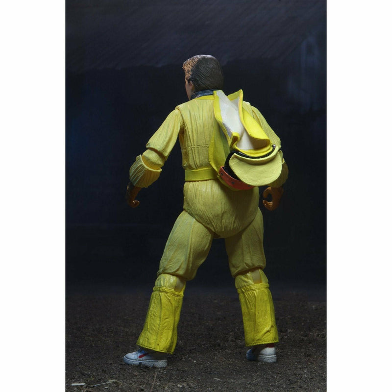 Action figure in a yellow suit with a backpack on a dark background