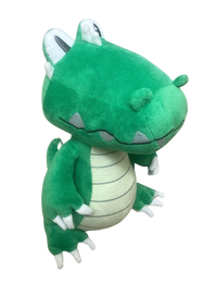 Green plush toy with white accents on a white background