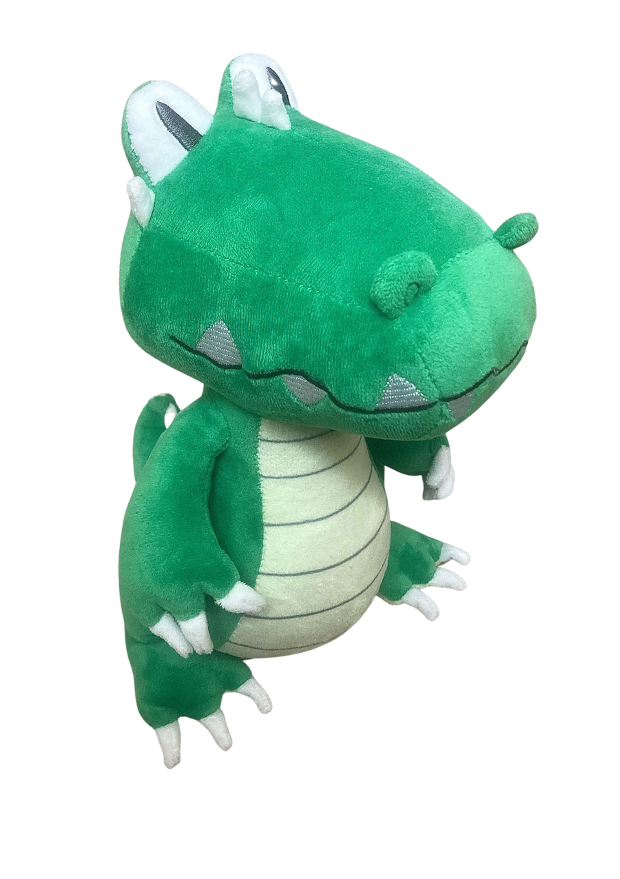 Green plush toy with white accents on a white background