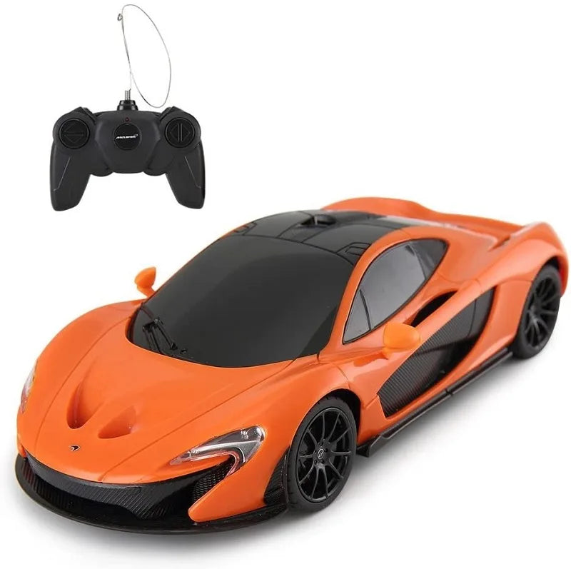 Orange toy car with black details and a remote control on a white background