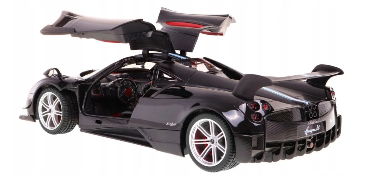 Black sports car with open gullwing doors on a white background
