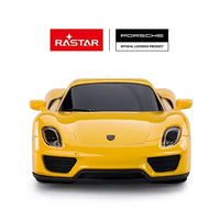 Yellow toy car with Rastar and Porsche logos on a white background