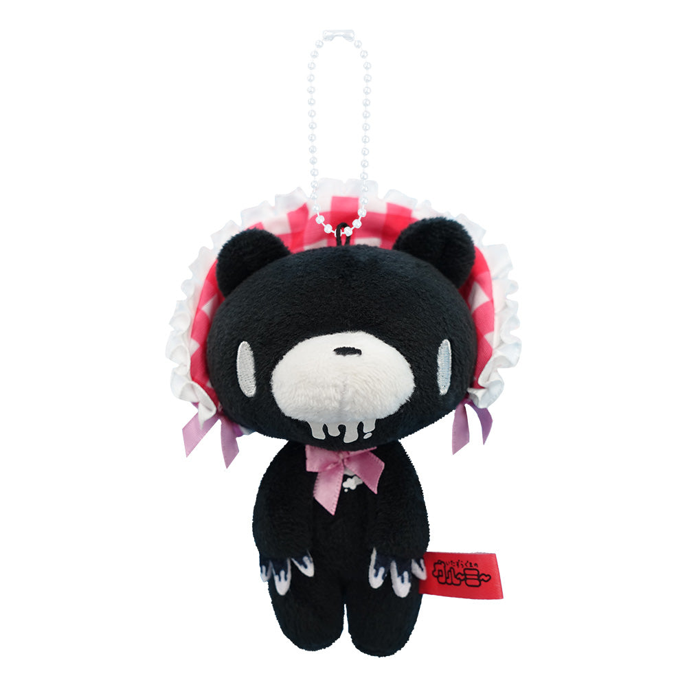 Black plush toy with red and white accents on a white background