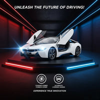 White BMW i8 car with open doors on a dark platform with red and blue lights, promotional text 'Unleash the Future of Driving!' displayed.