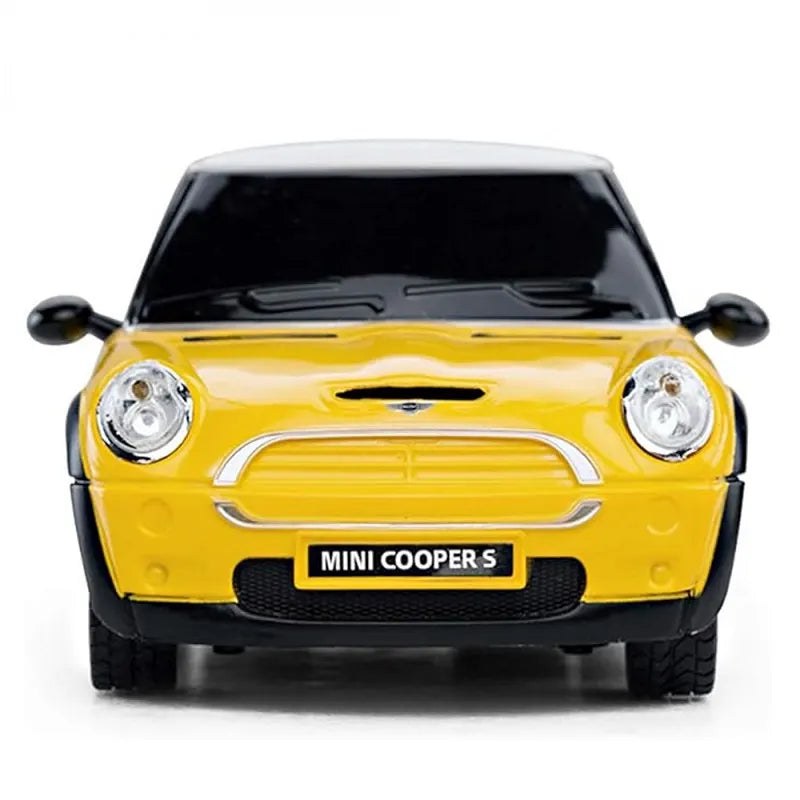 Yellow Mini Cooper S model car on a white background