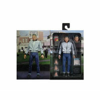 Action figure with packaging displaying a cityscape background