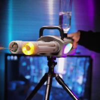 Lasershow projector on a tripod with colorful lights in the background