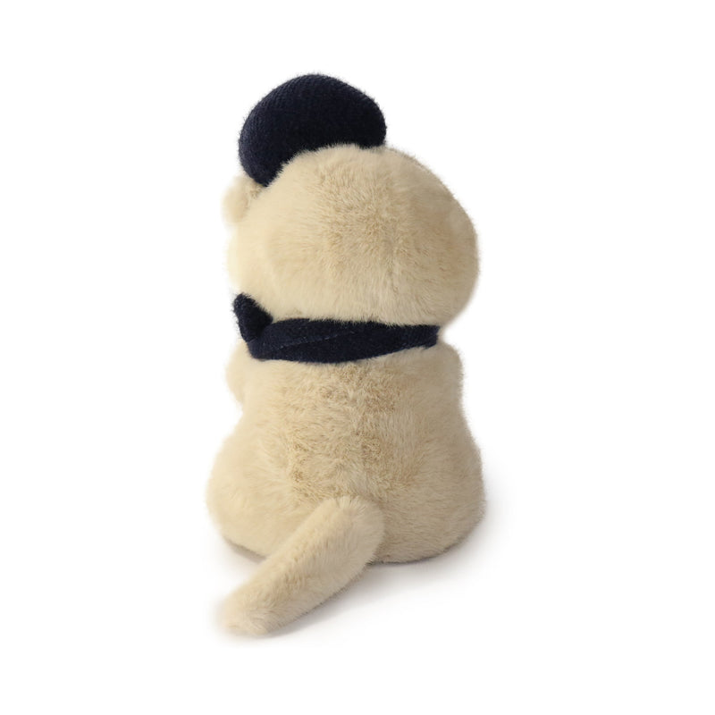 Plush toy pug dog with a black hat and scarf on a white background
