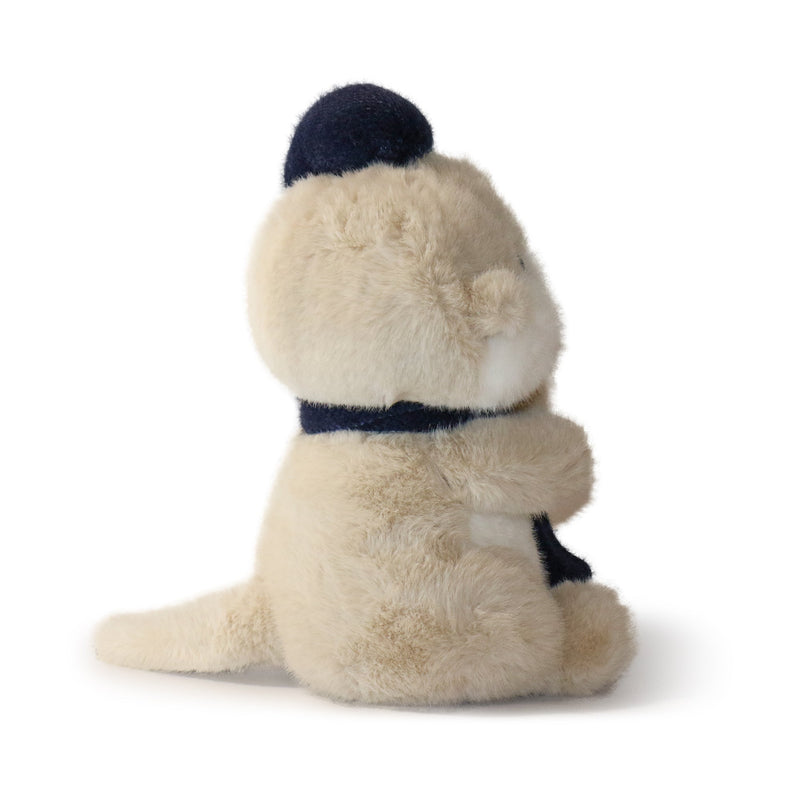 Plush toy otter with a navy hat and collar on a white background