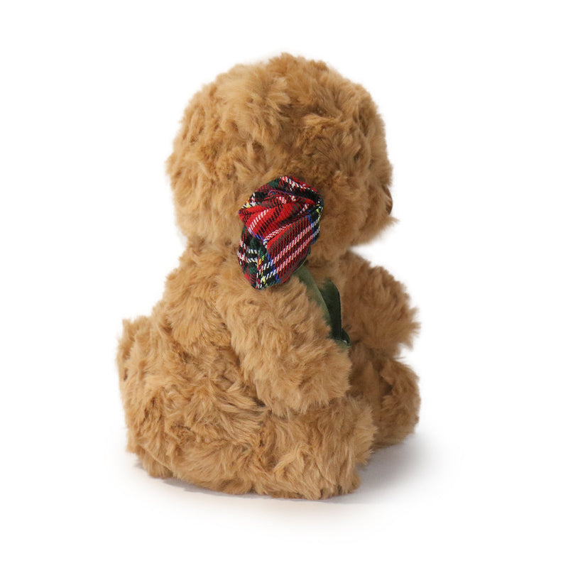 Brown teddy bear with a red and green plaid bow on a white background