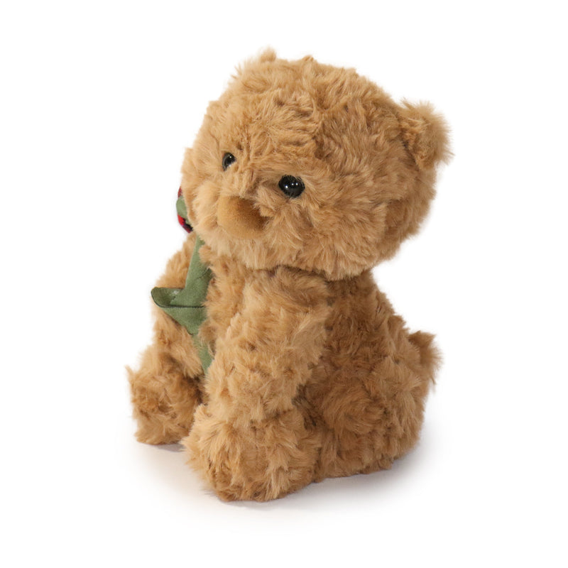 Brown teddy bear with a green bow tie on a white background