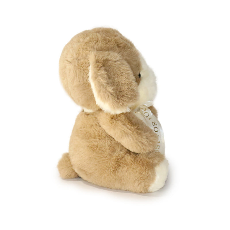 Plush bunny toy with a white label on a white background