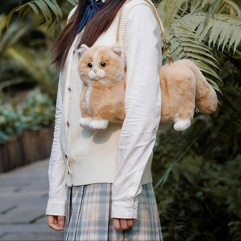 Person holding a plush cat toy with Chongker branding in a garden setting