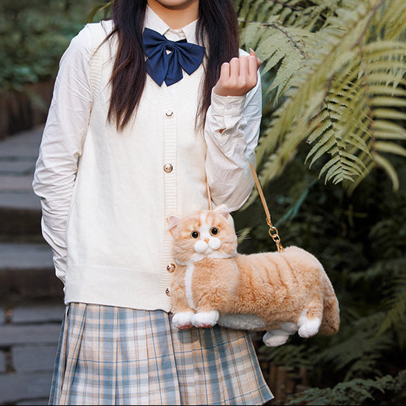 Woman holding a cat-shaped handbag with Chongker branding in an outdoor setting.