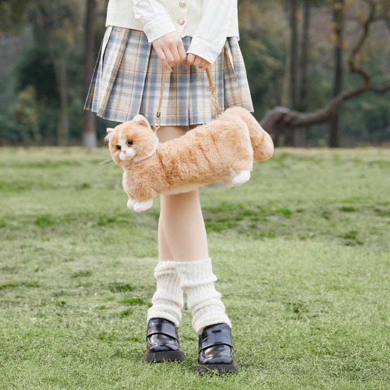 Person holding a plush cat bag outdoors with 'Chongker' branding.