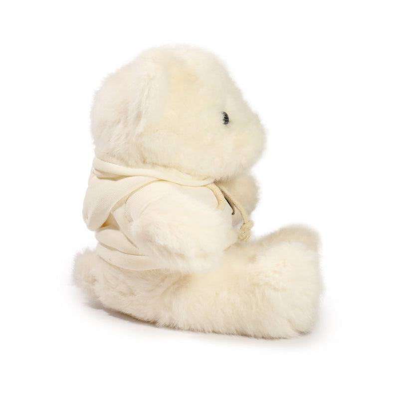White plush toy with a yellow ribbon on a white background
