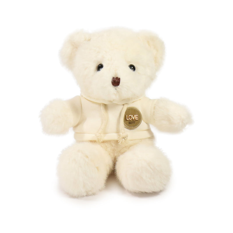 Cream-colored teddy bear with a gold tag on a white background