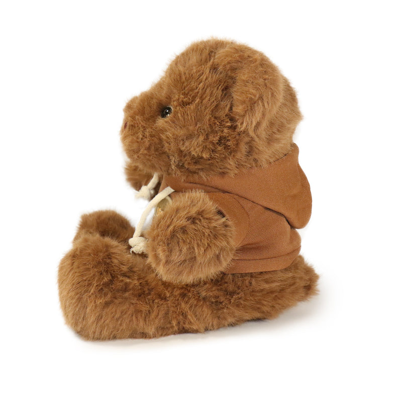 Brown plush animal toy with a coat on a white background