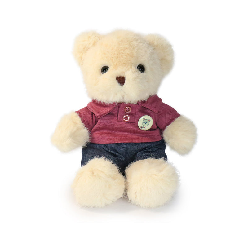Plush teddy bear wearing a red shirt and blue shorts on a white background