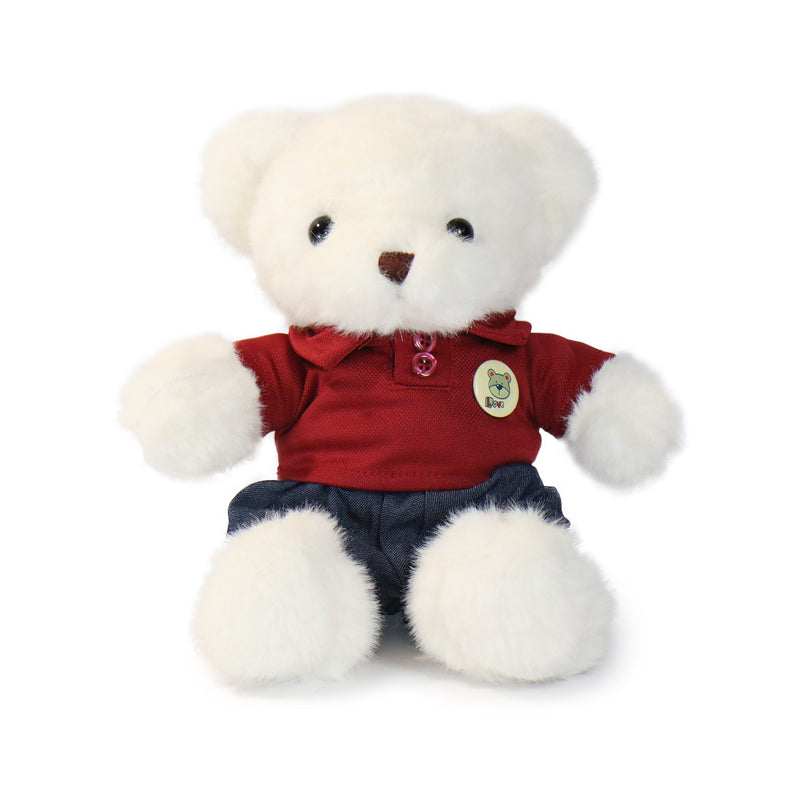 White teddy bear wearing a red shirt and blue shorts on a white background