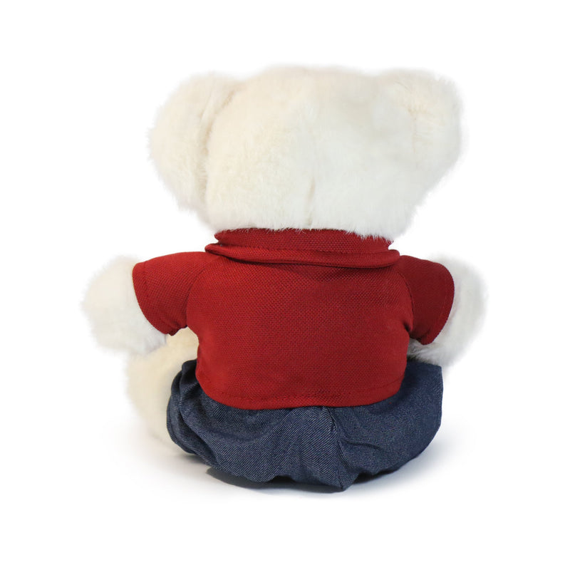Stuffed animal toy with a red shirt, blue pants, and white hat on a white background