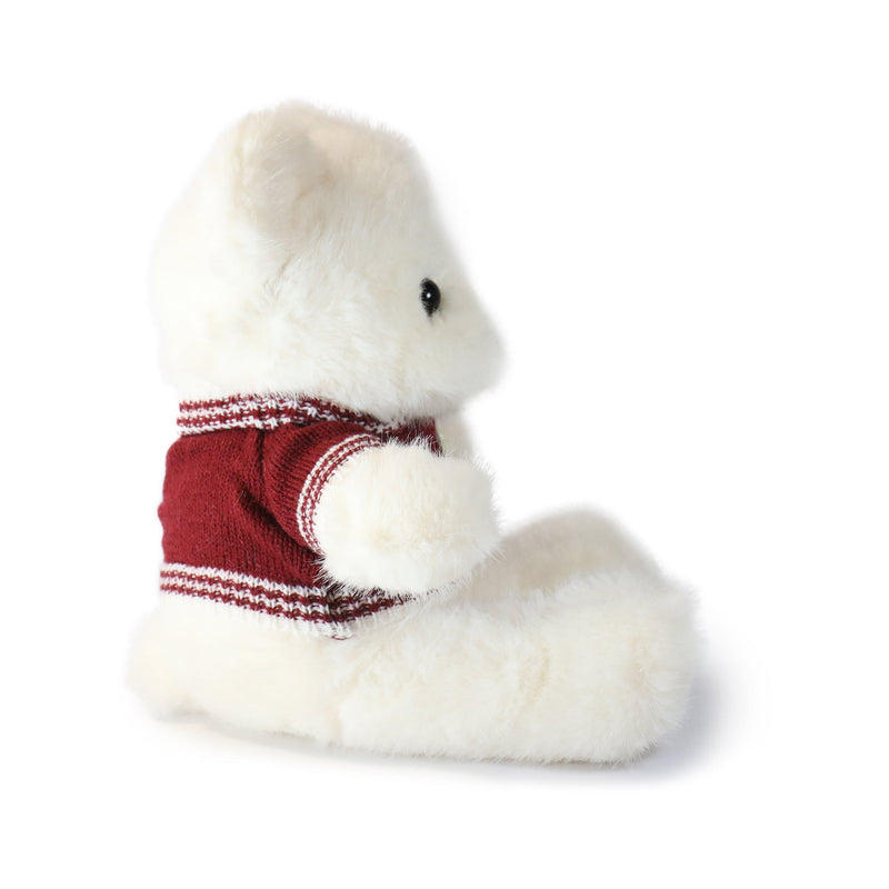 White plush animal wearing a red sweater on a white background