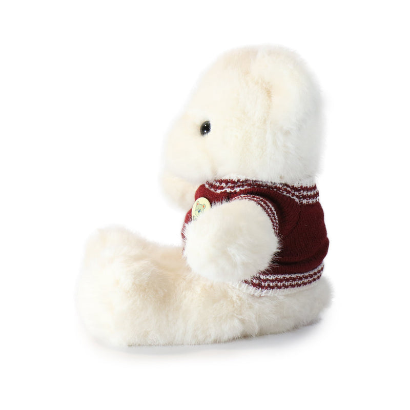 Plush toy dog with a red sweater on a white background
