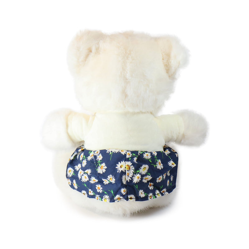 White teddy bear wearing a navy blue floral-patterned diaper on a white background