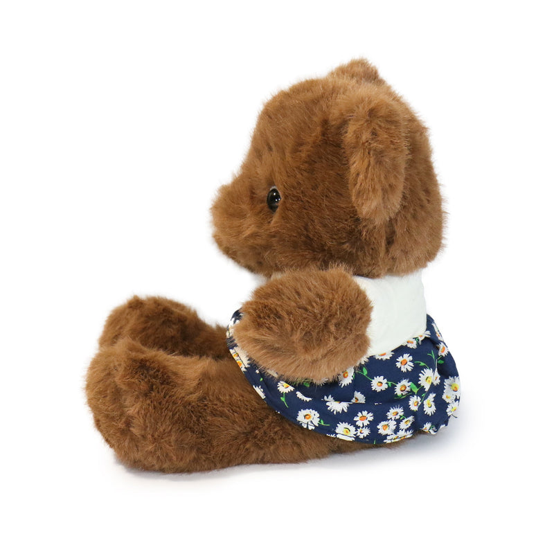 Plush toy dog with a floral bandana on a white background