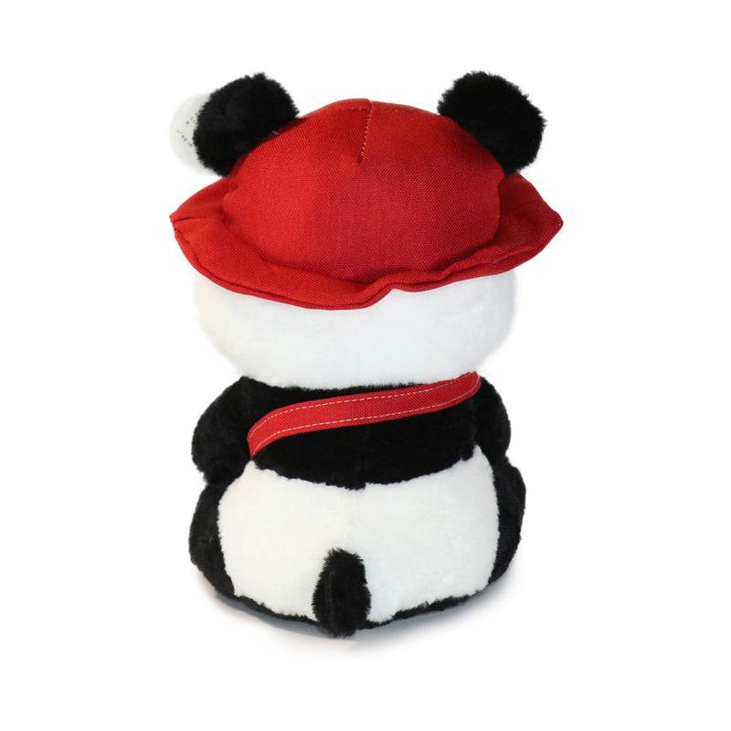 Plush toy panda with a red hat and scarf on a white background