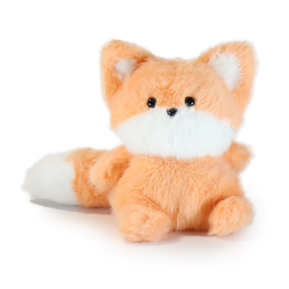Plush fox toy on a white background