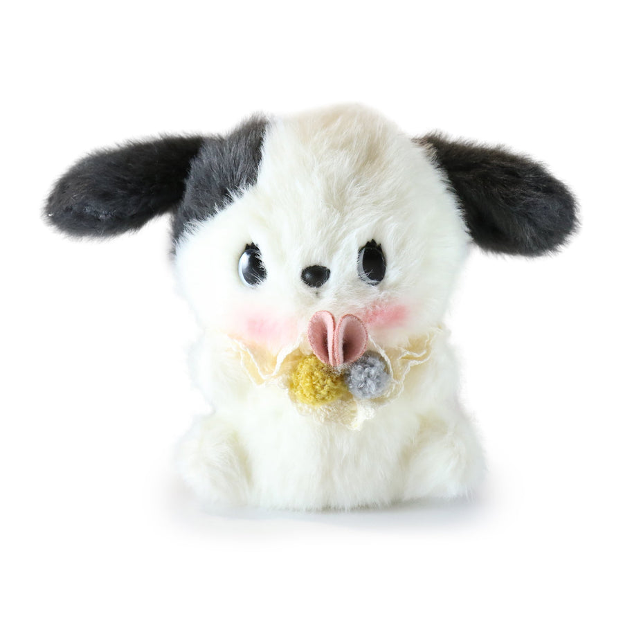 Plush toy resembling a dog with a bow tie on a white background