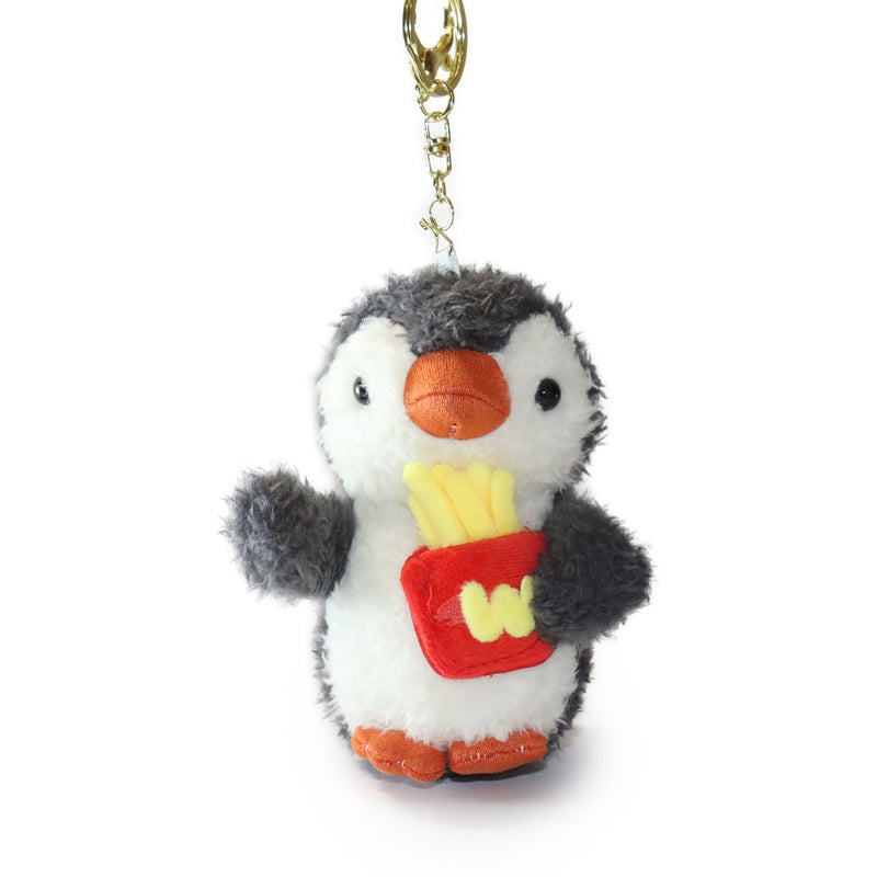 Plush penguin keychain holding a red bag with yellow stars on a white background