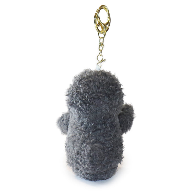 Gray plush keychain with a gold ring on a white background