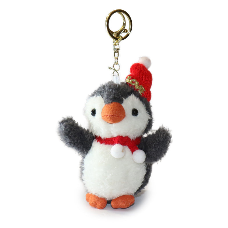 Plush penguin keychain with a red hat and scarf on a white background