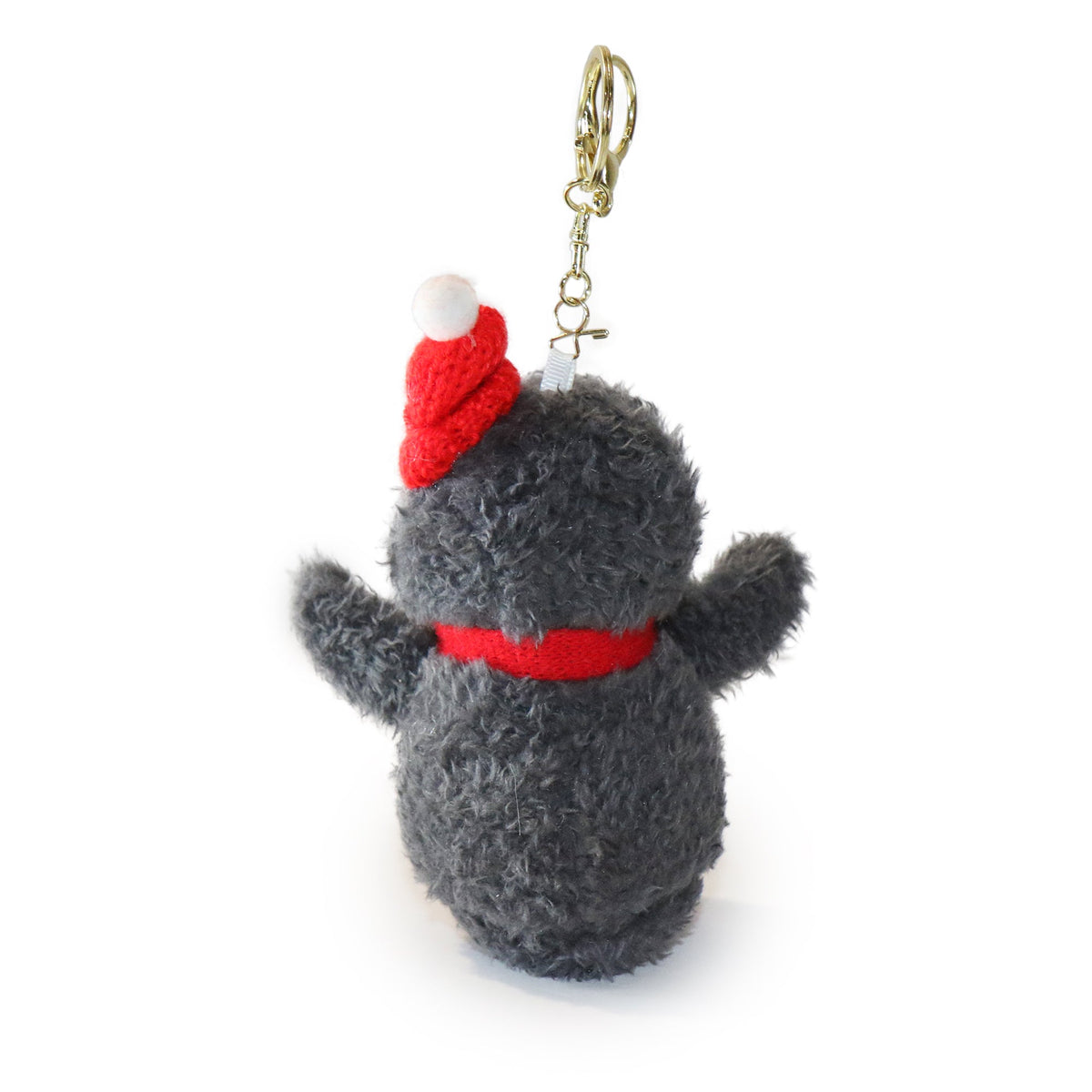 Plush keychain in the shape of a penguin wearing a red hat and scarf on a white background