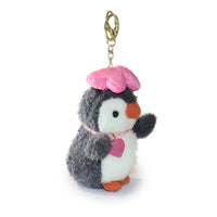 Plush penguin keychain with a pink hat and heart on a white background