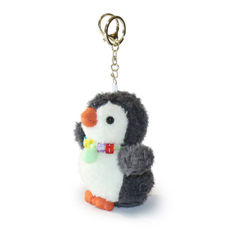 Plush penguin keychain with a gold ring on a white background