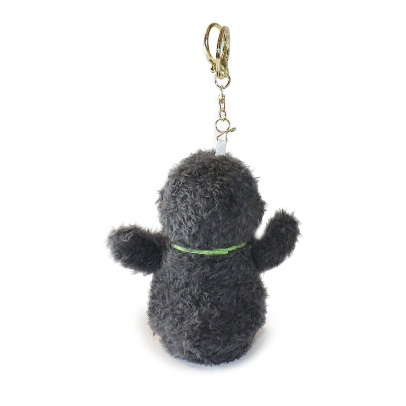 Plush keychain shaped like a dog with a green collar on a white background